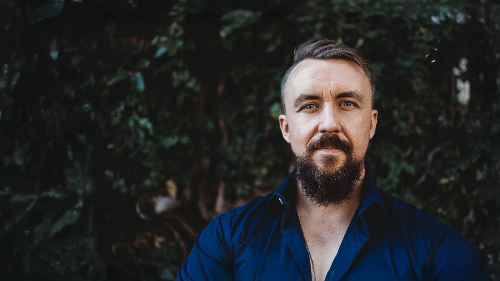 Anthony Clark in a green leafy garden setting